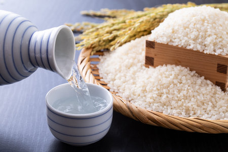 Japanese rice in a basket and rice in a wooden bowl on a black backgroundの写真素材