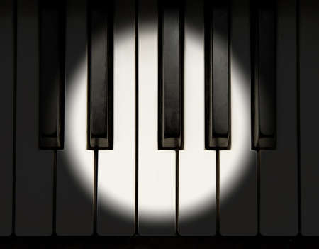 Spotlight on piano keyboardの写真素材