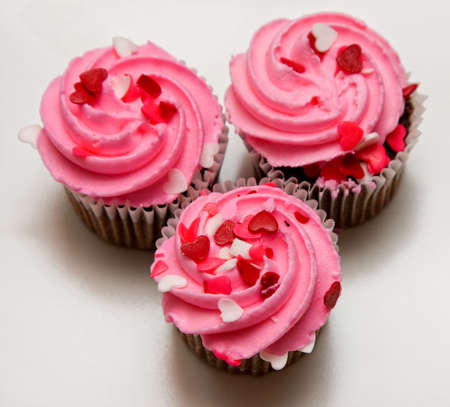 Pink cupcakes with heart sprinklesの写真素材