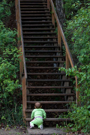 Baby at bottom of long staircaseの写真素材