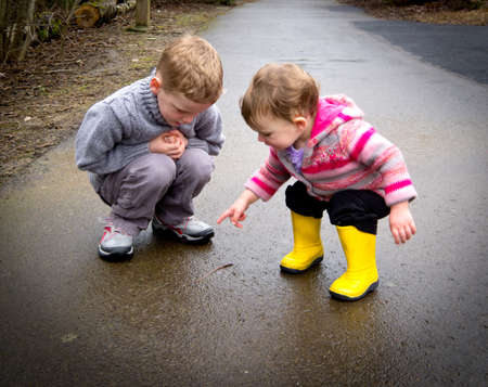 Kids watching worm on rainy day
