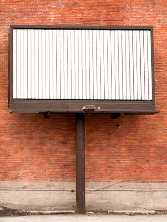 Three state rotating billboard against brick wall with blank messageの写真素材