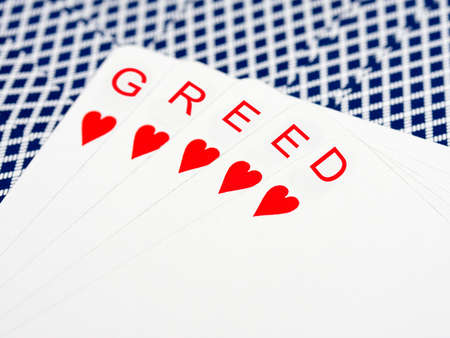 Greed in card handの写真素材