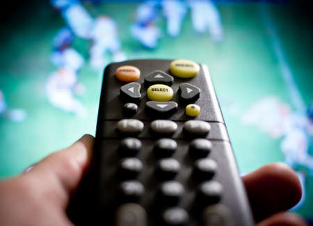 Watching sports / football on televisionの写真素材