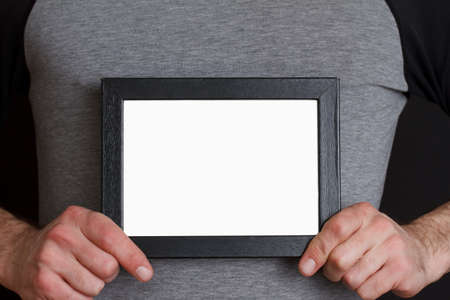 Young man with photograph in frameの写真素材