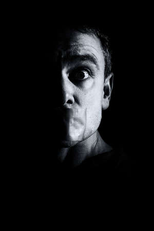 Man gagged with duct tapeの写真素材