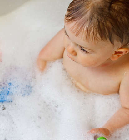 Baby in bubble bathの写真素材