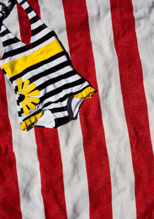 Childs bathing suit on towelの写真素材