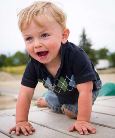 Happy baby boy at playgroundの写真素材