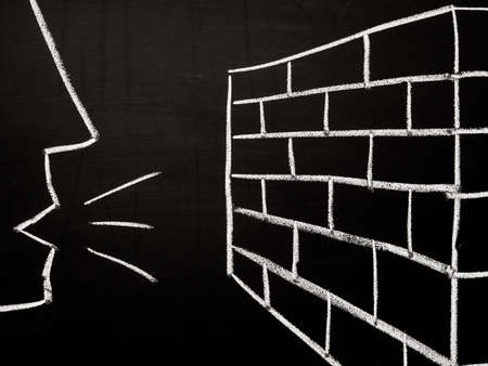 Talking to a brick wallの写真素材