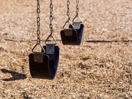 Swing set in empty playgroundの写真素材