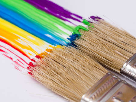 Paintbrushes painting rainbow colorsの写真素材