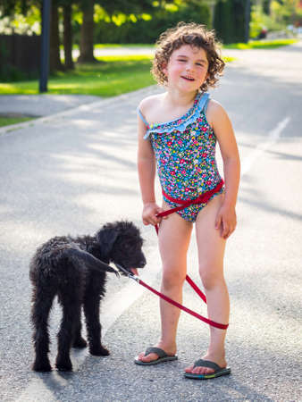 Cute girl walking puppyの写真素材