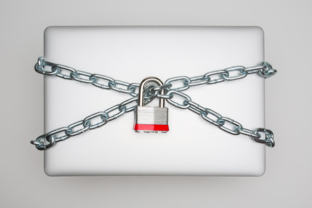 Laptop secured wrapped with a chain and deadboltの写真素材