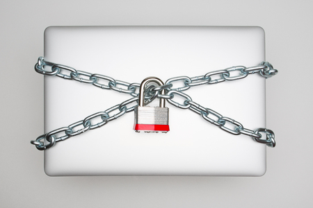 Laptop wrapped in Chainの写真素材