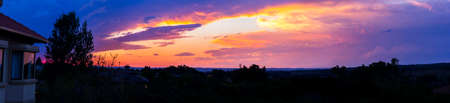 Beautiful Panoramic Sunset With Colorful Orange, Yellow and Purple Cloudsの写真素材
