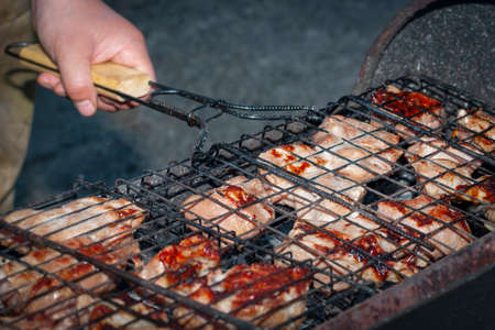 Grid with barbecue in hand.