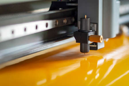Cutting plotter close-up. The process of cutting a vinyl film.の写真素材
