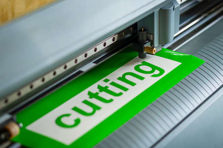 Cutting plotter close-up. The process of cutting a vinyl film.の写真素材
