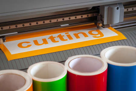 Cutting plotter close-up. The process of cutting a vinyl film.の写真素材