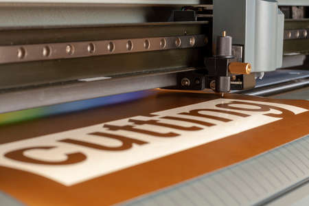 Cutting plotter close-up. The process of cutting a vinyl film.