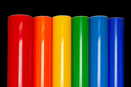 Rolls of colored vinyl film isolated on a black background.の写真素材