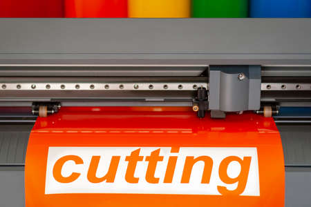 Cutting plotter close-up. The process of cutting a vinyl film.の写真素材