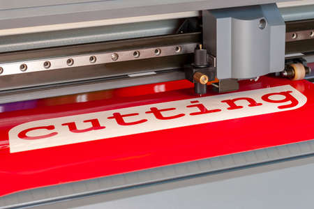 Cutting plotter close-up. The process of cutting a vinyl film.