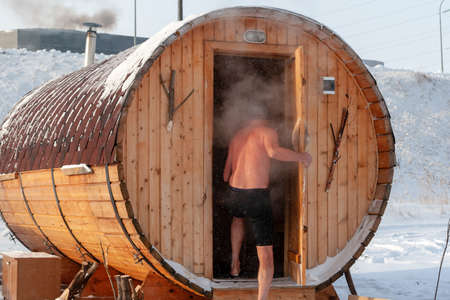 Surgut, Russia, 11 october 2018: A lover of winter swimming enters the sauna after bathing in cold water. Opening of the winter swimming season.のeditorial素材