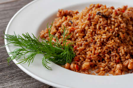 Healthy diet. Vegan pilaf with rice, carrots and dried fruits: chickpeas, prunes, dried apricots,...