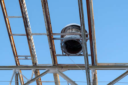 Metal beams at the top of the unfinished steel structure of the building under construction, against the blue sky.の写真素材