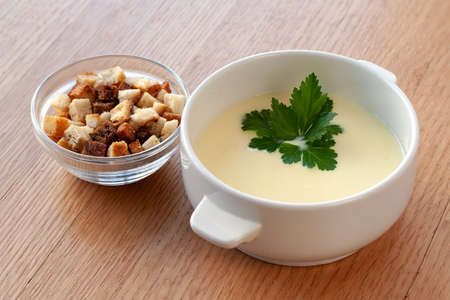 Vegetarian dish. Cheese cream soup with cream, potatoes and spices, decorated with herbs.