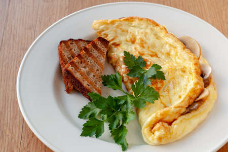 Vegetarian dish. Scrambled eggs with Champignons, herbs and croutons.