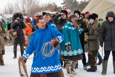 Russkinskaya, Surgut, Russia, 03/23/19: open traditional holiday of the peoples of Siberia. Feast of reindeer herders. Reindeer herders in national costumes participate in lasso throwing competitions.のeditorial素材