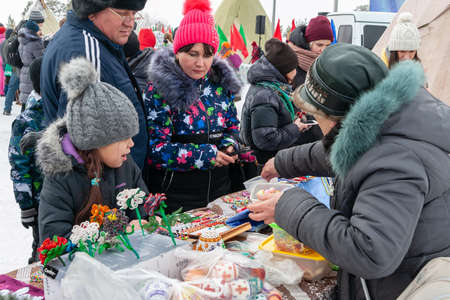 Russkinskaya, Surgut, Russia, 03/23/2019: open traditional holiday of reindeer herders and fishermen, indigenous peoples of Siberia. Trade Northern Souvenirs at the holiday fair.のeditorial素材
