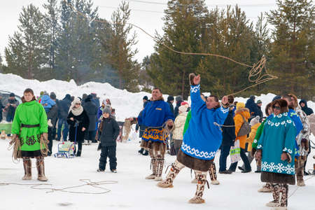Russkinskaya, Surgut, Russia, 03/23/2019: open traditional holiday of reindeer herders and fishermen, indigenous peoples of Siberia. National martial arts of Siberia - throwing tynzyan.のeditorial素材