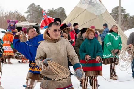 Russkinskaya, Surgut, Russia, 03/23/2019: open traditional holiday of reindeer herders and fishermen, indigenous peoples of Siberia. National martial arts of Siberia - throwing lasso.のeditorial素材