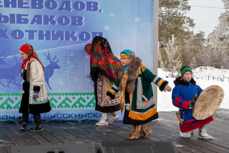 Russkinskaya, Surgut, Russia, 03/23/2019: open traditional holiday of reindeer herders and fishermen, indigenous peoples of Siberia. The performance of the children folklore group on the stage.のeditorial素材