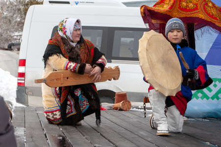 Russkinskaya, Surgut, Russia, 03/23/2019: open traditional holiday of reindeer herders and fishermen, indigenous peoples of Siberia. The performance of the children folklore group on the stage.のeditorial素材