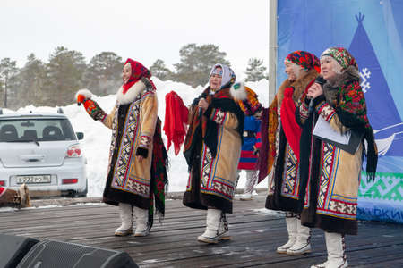 Russkinskaya, Surgut, Russia, 03/23/2019: open traditional holiday of reindeer herders and fishermen, indigenous peoples of Siberia. The performance of the folklore group on the stage.のeditorial素材