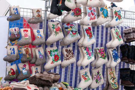 Russkinskaya, Surgut, Russia, 03/23/2019: open traditional holiday of reindeer herders and fishermen, indigenous peoples of Siberia. Showcase traditional Russian Felt boots.のeditorial素材