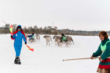 Russkinskaya, Surgut, Russia, 03/23/2019: open traditional holiday of reindeer herders and fishermen, indigenous peoples of Siberia. The participants of reindeer races at the start.のeditorial素材