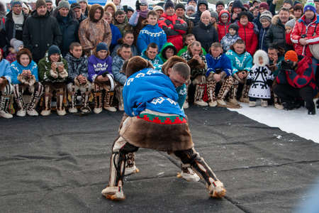 Russkinskaya, Surgut, Russia, 03/23/2019: open traditional holiday of reindeer herders and fishermen, indigenous peoples of Siberia. Fight participants in the national struggle.のeditorial素材
