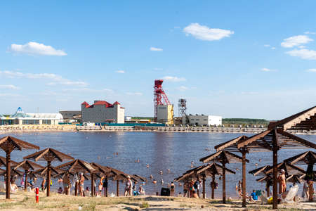 Sol-Iletsk, Russia, 08.27.2020. View of the salt-mining enterprise - Russol. View of the beach with tourists resting on the Salt Lakes. Lake Razval. Sol-Iletsk resort.のeditorial素材