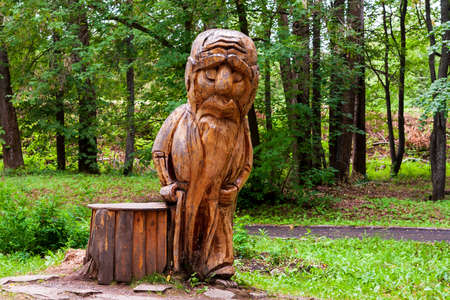Kungur, Russia, 07.22.2021 Stylized wooden sculpture of an old forest man. The territory of the tourist complex is the Kungur Ice Cave.のeditorial素材