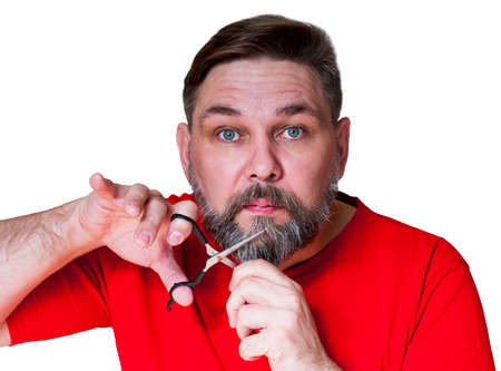 Middle aged man with gray beard isolated on white. A man wants to cut off his beard with scissors.
