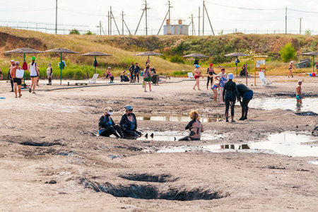 Sol-Iletsk, Russia, 07.27.2022. People at the Sol-Iletsk resort. People take mud treatments on their own.のeditorial素材