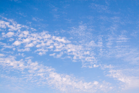 Blue sky with unusual clouds. Spindrift clouds.