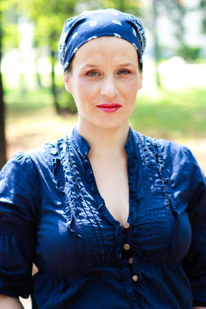 Green-eyed beautiful pregnant young woman dressed in blueの写真素材