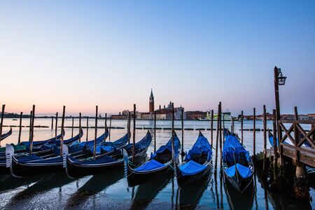 Gondolas in Venice, Italy at sunriseの写真素材